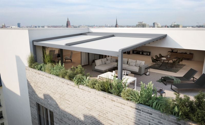 markilux pergola stretch on the terrace of a penthouse. view from above of the extended awning, light fabric cover, gray frame.