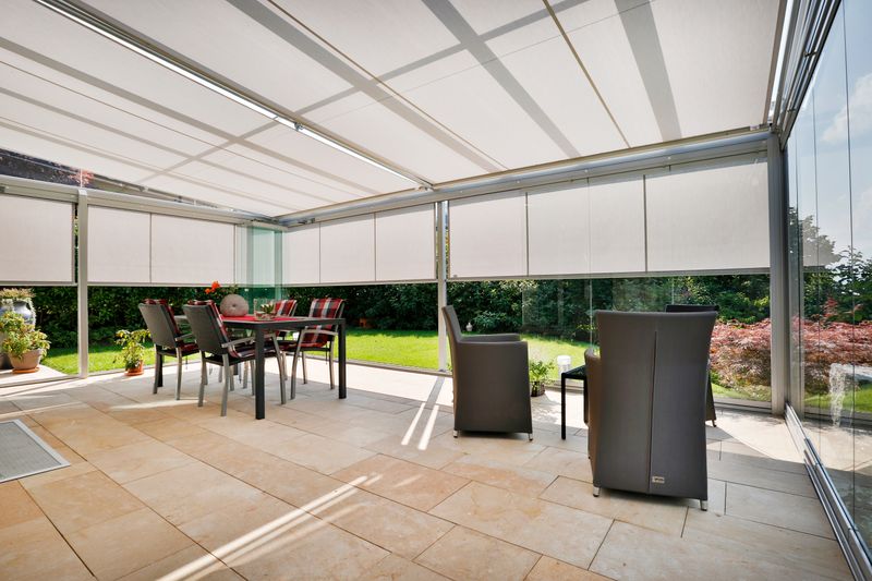 Interior view of conservatory with markilux 889 under-glass awning and markilux 710 vertical blind in gray to match the color of the conservatory.