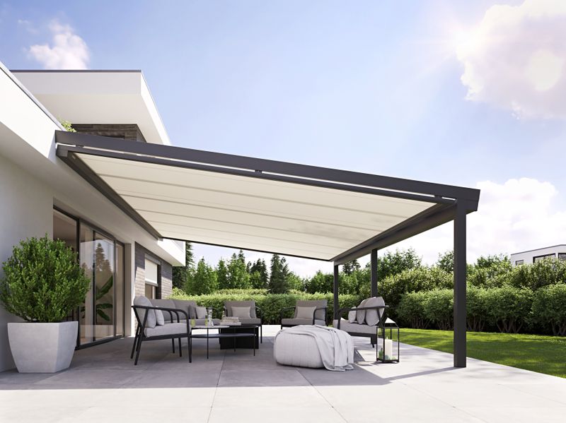 Underglass awning markilux 779 with white fabric cover under a patio roof on a single-family house.