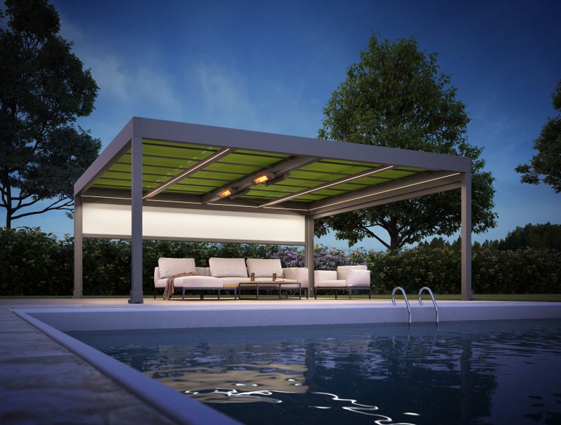 Free-standing awning system markilux markant with lighting and infrared heater at a pool in the evening.