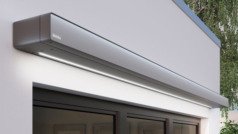 Cassette awning markilux 970 dark gray with LED line on white wall