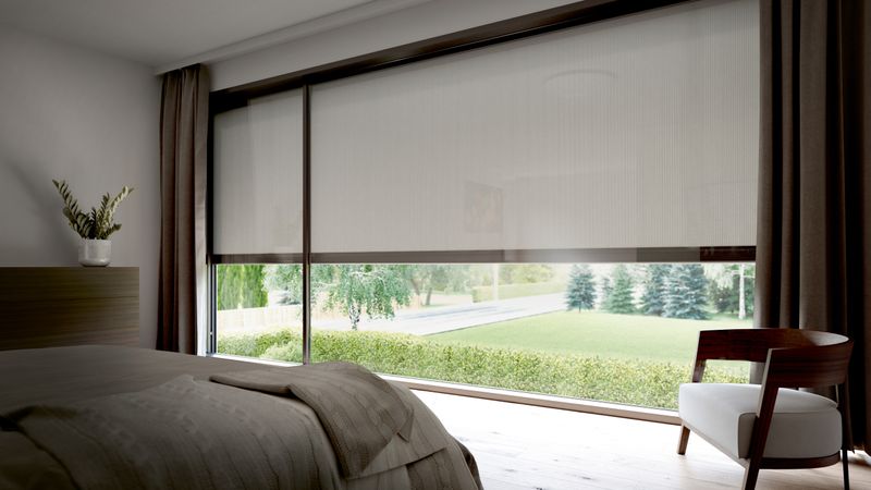 View from the bedroom to the outside. The vertical blaind awnings markilux 876 with white fabric cover are half lowered.