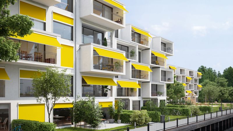 markilux 730 com cobertura de tecido amarelo e moldura branca em várias varandas de um edifício de apartamentos
