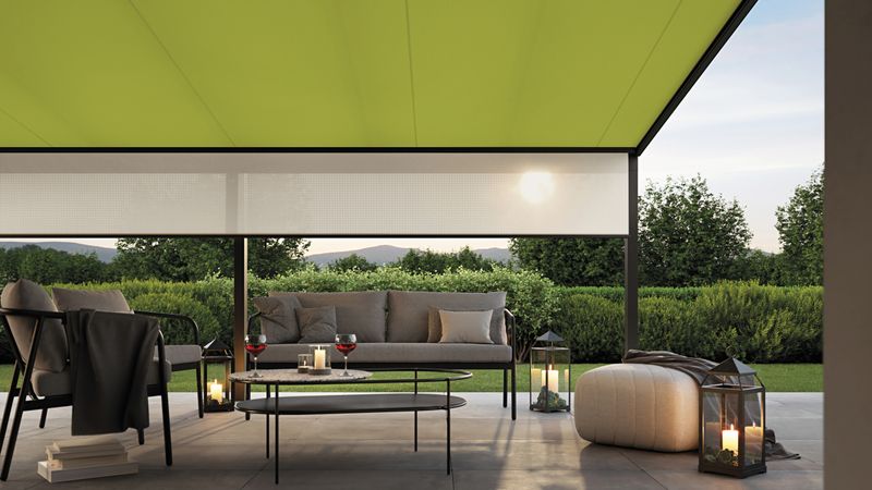 View from the house to the terrace shaded by an under glass awning 779 with green fabric cover and beige shadeplus