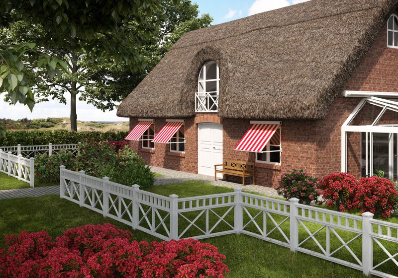 Brick house with thatched roof, in front of the windows are white drop-arm cassette awnings markilux 730 with red and white striped fabric cover.