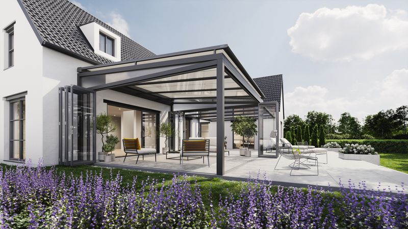 On-glass awning markilux 7800 mounted above a winter garden. A large garden surrounds the terrace and in the background is a new construction house.