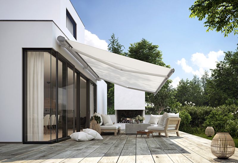 markilux awning with silver frame and cream fabric cover in front of the terrace of a family house