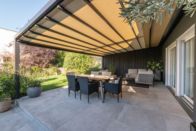 markilux pergola stretch with light fabric. covering a private terrace in a modern design.