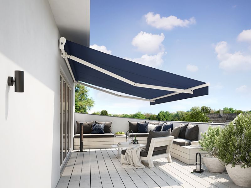 markilux 1300 in white with blue fabric over a balcony on a white house wall