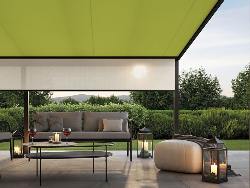 View from the house to the terrace shaded by an under glass awning 779 with green fabric cover and beige shadeplus