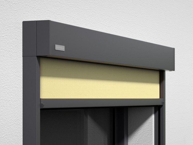 Vista detallada del toldo cofre vertical markilux 620: marco gris, tejido amarillo claro, montaje en pared.