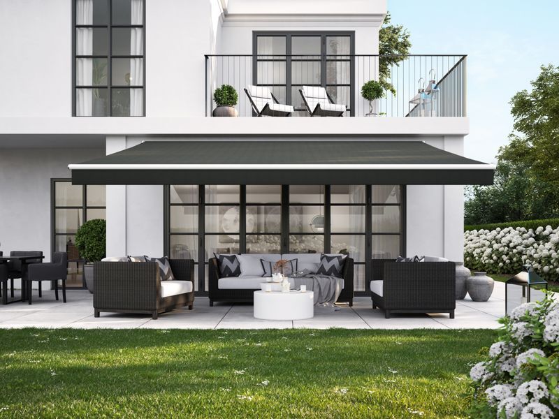 White urban villa with white awning markilux 1700 with black fabric cover and straight valance.