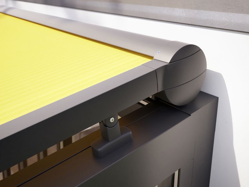 Detail view of cassette of top glass awning markilux 8800, yellow fabric cover.