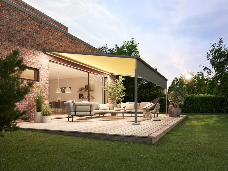 Pergola compact on the terrace of a brick house. The awning is illuminated by LED Line