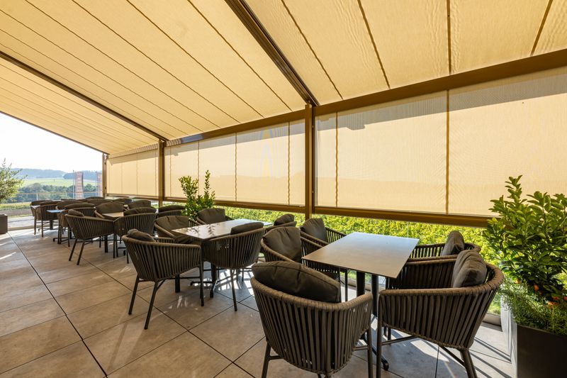Reference image mx pergola stretch cubic as large-area shading for gastronomy above a terrace in Mehrnbach, Austria