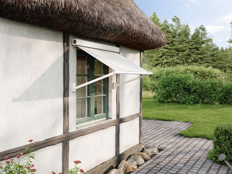 Extended awning mx 730 with cream-colored fabric and frame attached to a thatched house