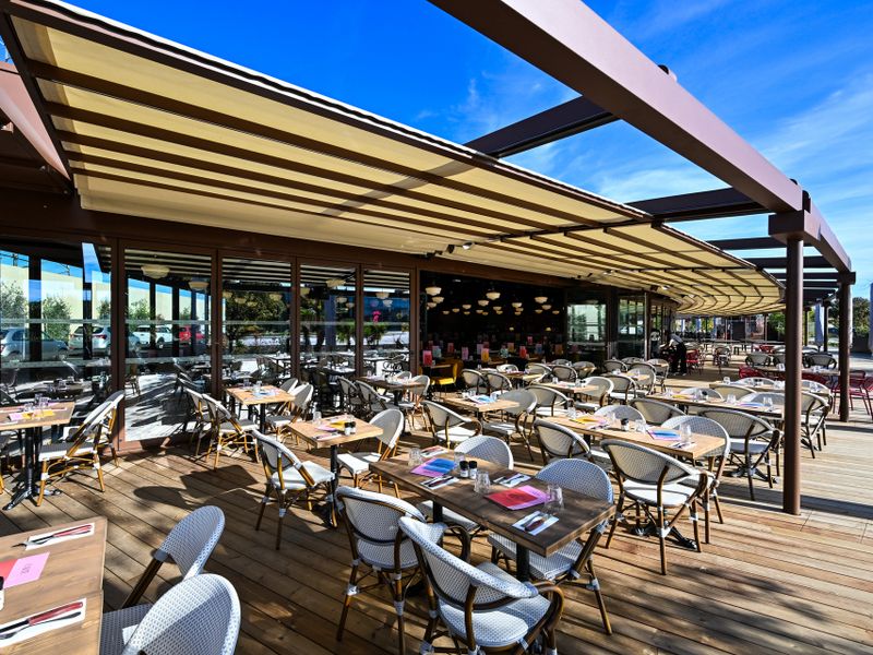Large awning system, half open, at a restaurant complex.