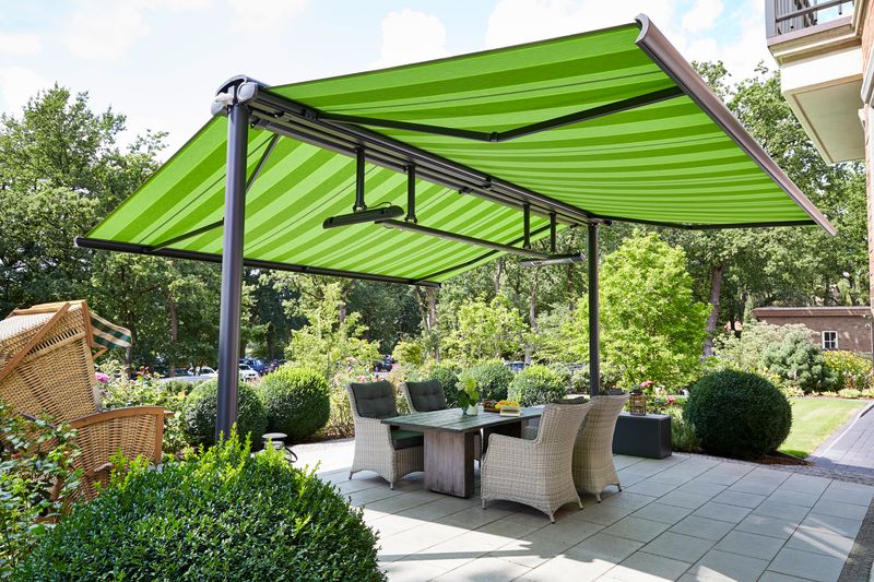 markilux syncra with cassette awning markilux 5010 (frame anthracite, fabric cover green striped) mounted on both sides equipped with infrared heaters and LED-Spotline.